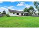 Expansive backyard with well-maintained lawn, patio seating, screened in patio, and fenced perimeter at 572 Quail Ridge Dr, Westfield, IN 46074