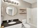 Well-lit bathroom featuring granite countertops, a white vanity, and decorative wood shelving at 572 Quail Ridge Dr, Westfield, IN 46074