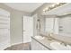 Bright bathroom featuring a double sink vanity with a large mirror and decorative lighting at 572 Quail Ridge Dr, Westfield, IN 46074
