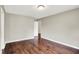 Light-filled bedroom with hardwood floors, neutral walls, and a doorway creating a warm ambiance at 572 Quail Ridge Dr, Westfield, IN 46074