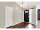 Bright foyer featuring wood floors, a dark front door with glass, and a white interior door at 572 Quail Ridge Dr, Westfield, IN 46074