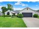 Charming ranch home featuring a well-manicured lawn, a gray garage door, and manicured shrubs at 572 Quail Ridge Dr, Westfield, IN 46074