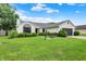 Charming ranch home featuring a well-manicured lawn, a gray garage door, and manicured shrubs at 572 Quail Ridge Dr, Westfield, IN 46074