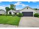 Charming ranch home featuring a well-manicured lawn, a gray garage door, and manicured shrubs at 572 Quail Ridge Dr, Westfield, IN 46074