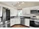 Bright kitchen with stainless steel appliances, white cabinets, and modern design at 572 Quail Ridge Dr, Westfield, IN 46074