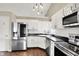 Well-equipped kitchen featuring stainless steel appliances, white cabinets, and ample counter space at 572 Quail Ridge Dr, Westfield, IN 46074