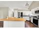 Modern kitchen with stainless steel appliances and wooden butcher block island at 572 Quail Ridge Dr, Westfield, IN 46074