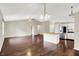 Open-concept area showcasing hardwood floors, kitchen island, and modern lighting at 572 Quail Ridge Dr, Westfield, IN 46074