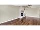 Living room featuring wood floors, vaulted ceilings, a fan, and a brick fireplace at 572 Quail Ridge Dr, Westfield, IN 46074
