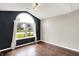 Bright living room featuring wood floors, vaulted ceilings, and a large arched window at 572 Quail Ridge Dr, Westfield, IN 46074