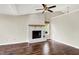 Living room featuring wood floors, vaulted ceilings, a fan, and a brick fireplace at 572 Quail Ridge Dr, Westfield, IN 46074