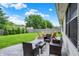Patio with wicker and Adirondack seating overlooking the lush backyard at 572 Quail Ridge Dr, Westfield, IN 46074