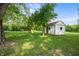 Spacious backyard featuring a storage shed, swing set, and mature trees at 5811 Simmul Cir, Indianapolis, IN 46221