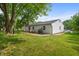 Exterior view of backyard with a patio, grill, and well-maintained lawn at 5811 Simmul Cir, Indianapolis, IN 46221