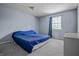 Bright bedroom with soft blue walls, plush carpet, and a comfortable bed with blue bedding at 5811 Simmul Cir, Indianapolis, IN 46221