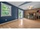 Charming dining area featuring wood floors, a brick fireplace, and a sliding door to the backyard at 5811 Simmul Cir, Indianapolis, IN 46221