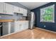 Bright kitchen features stainless steel appliances, white cabinets, and light countertops at 5811 Simmul Cir, Indianapolis, IN 46221
