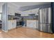 Bright kitchen features stainless steel appliances, white cabinets, and wood countertops at 5811 Simmul Cir, Indianapolis, IN 46221