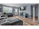 Spacious living area with wood floors, fireplace, TV, large windows, and comfortable seating at 5811 Simmul Cir, Indianapolis, IN 46221