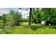 Expansive backyard featuring a pond, storage shed, and lush greenery, offering a serene outdoor retreat at 600 Old Moore Rd, Martinsville, IN 46151