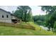 Expansive backyard featuring a wooden fence with mature landscaping, with pond view at 600 Old Moore Rd, Martinsville, IN 46151