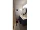 A blue vanity with a unique sink sits under an oval mirror in this well-lit bathroom at 600 Old Moore Rd, Martinsville, IN 46151