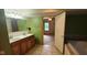 Bathroom with double sink vanity, tile flooring, with jacuzzi tub in adjacent space at 600 Old Moore Rd, Martinsville, IN 46151