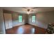 Cozy bedroom with hardwood floors, neutral walls, and ample natural light from two windows at 600 Old Moore Rd, Martinsville, IN 46151
