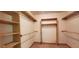 Walk-in closet with custom shelving and hanging rods at 600 Old Moore Rd, Martinsville, IN 46151