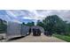 View of a concrete driveway with an outbuilding, trailer, truck and atv with lawn at 600 Old Moore Rd, Martinsville, IN 46151