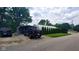 Gravel driveway and parking area, featuring an outbuilding, carports, and lush green foliage at 600 Old Moore Rd, Martinsville, IN 46151