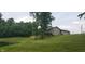 A charming home nestled in a serene landscape, complete with a picturesque pond and lush greenery at 600 Old Moore Rd, Martinsville, IN 46151