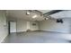 Spacious garage featuring epoxy flooring, neutral walls, and modern lighting fixtures at 600 Old Moore Rd, Martinsville, IN 46151