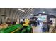 Spacious outbuilding area with equipment, including a mower, vehicle, and storage shelves at 600 Old Moore Rd, Martinsville, IN 46151
