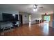 Spacious living room featuring hardwood floors, ceiling fans and adjacent sunroom at 600 Old Moore Rd, Martinsville, IN 46151