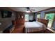 Spacious primary bedroom with a ceiling fan, wood floors, and abundant natural light at 600 Old Moore Rd, Martinsville, IN 46151