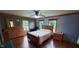 Spacious primary bedroom with a ceiling fan, wood floors, and abundant natural light at 600 Old Moore Rd, Martinsville, IN 46151
