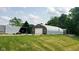 View of a modern outbuilding, with steel frame and stone facade, beside a grassy yard at 600 Old Moore Rd, Martinsville, IN 46151