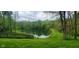 The idyllic pond is surrounded by lush greenery, offering a serene and picturesque view at 600 Old Moore Rd, Martinsville, IN 46151