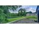 A tranquil pond with green trees reflecting in the water, framed by the home and lush vegetation at 600 Old Moore Rd, Martinsville, IN 46151