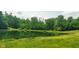 Scenic view of a tranquil pond surrounded by lush greenery, creating a peaceful and picturesque setting at 600 Old Moore Rd, Martinsville, IN 46151