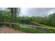 Enjoy a peaceful view of the pond from the deck with black metal railings at 600 Old Moore Rd, Martinsville, IN 46151
