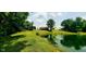 Picturesque pond view surrounded by trees and greenery, featuring an open backyard at 600 Old Moore Rd, Martinsville, IN 46151