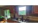 Granite counters paired with a dual basin sink overlooking the backyard at 600 Old Moore Rd, Martinsville, IN 46151