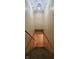 Carpeted staircase leading to a lower level, lit by a modern light fixture at 600 Old Moore Rd, Martinsville, IN 46151