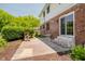 Backyard patio with brick home and lush greenery offers a serene outdoor living space at 6146 Rucker Rd, Indianapolis, IN 46220