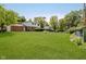 Expansive backyard features lush green grass, mature trees, and a well-maintained lawn at 6146 Rucker Rd, Indianapolis, IN 46220