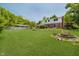 Spacious backyard features lush green grass, mature trees, and a fire pit for outdoor gatherings at 6146 Rucker Rd, Indianapolis, IN 46220