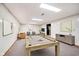 Finished basement features a billiard table, recessed lighting, and ample space for entertaining guests at 6146 Rucker Rd, Indianapolis, IN 46220