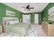 Bright main bedroom is painted in green with an elegant, tufted headboard at 6146 Rucker Rd, Indianapolis, IN 46220
